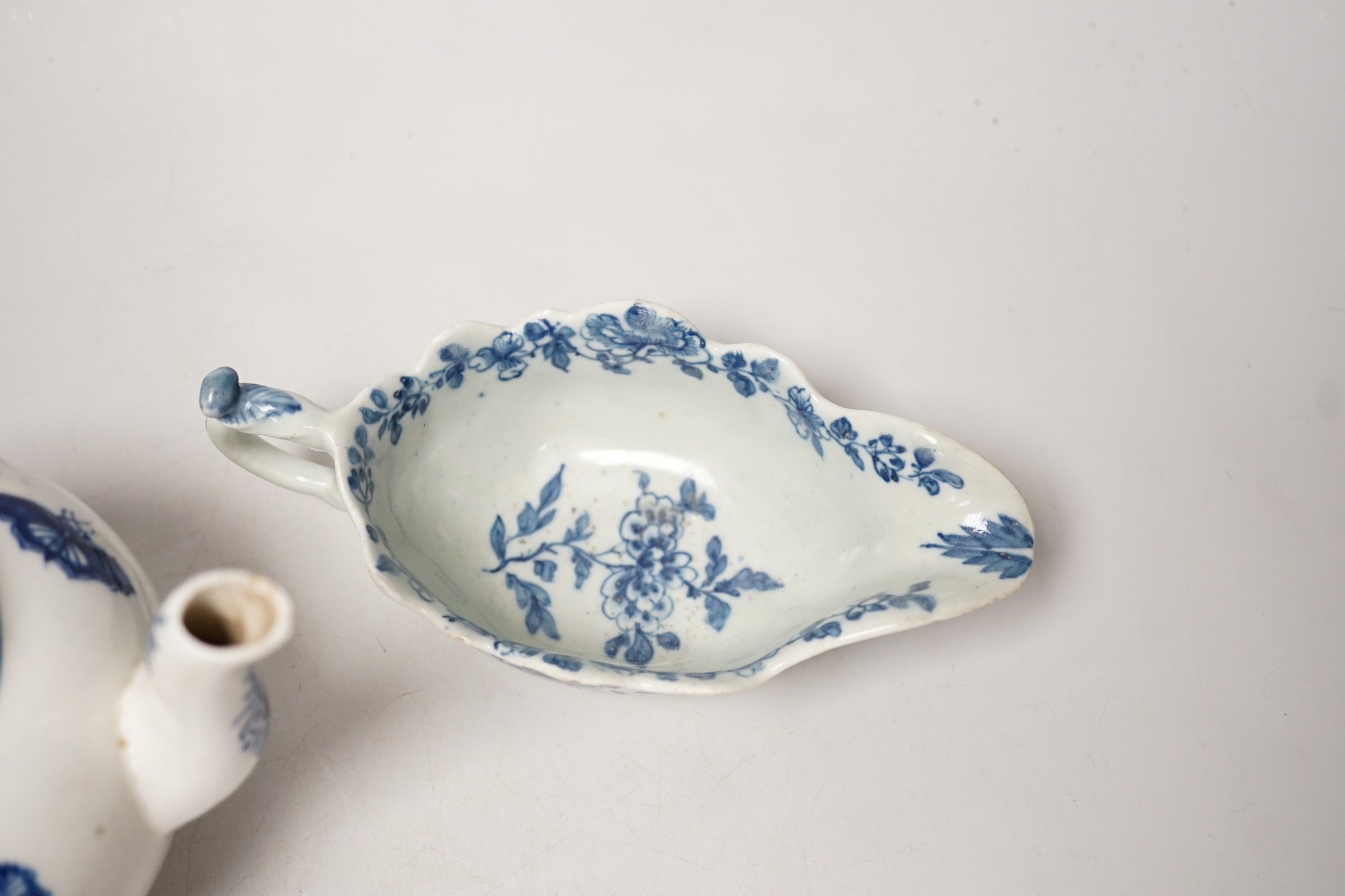 A Liverpool porcelain blue and white sauceboat and a Worcester teapot. Tallest 12cm